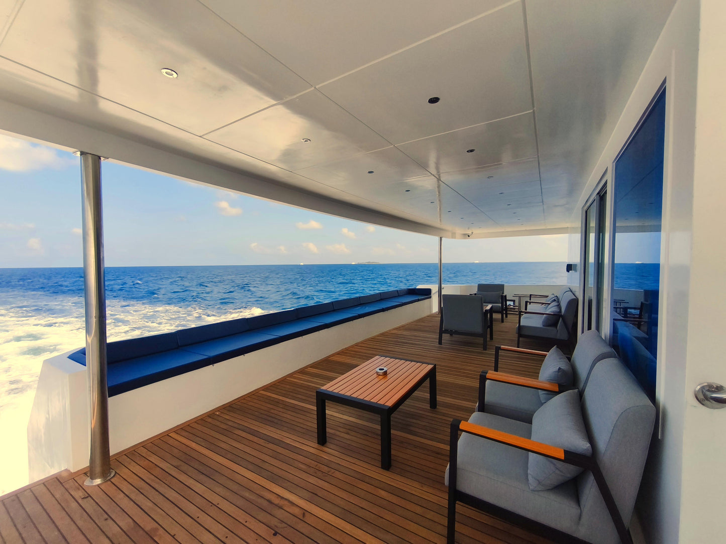 Yacht deck with seating area and ocean view