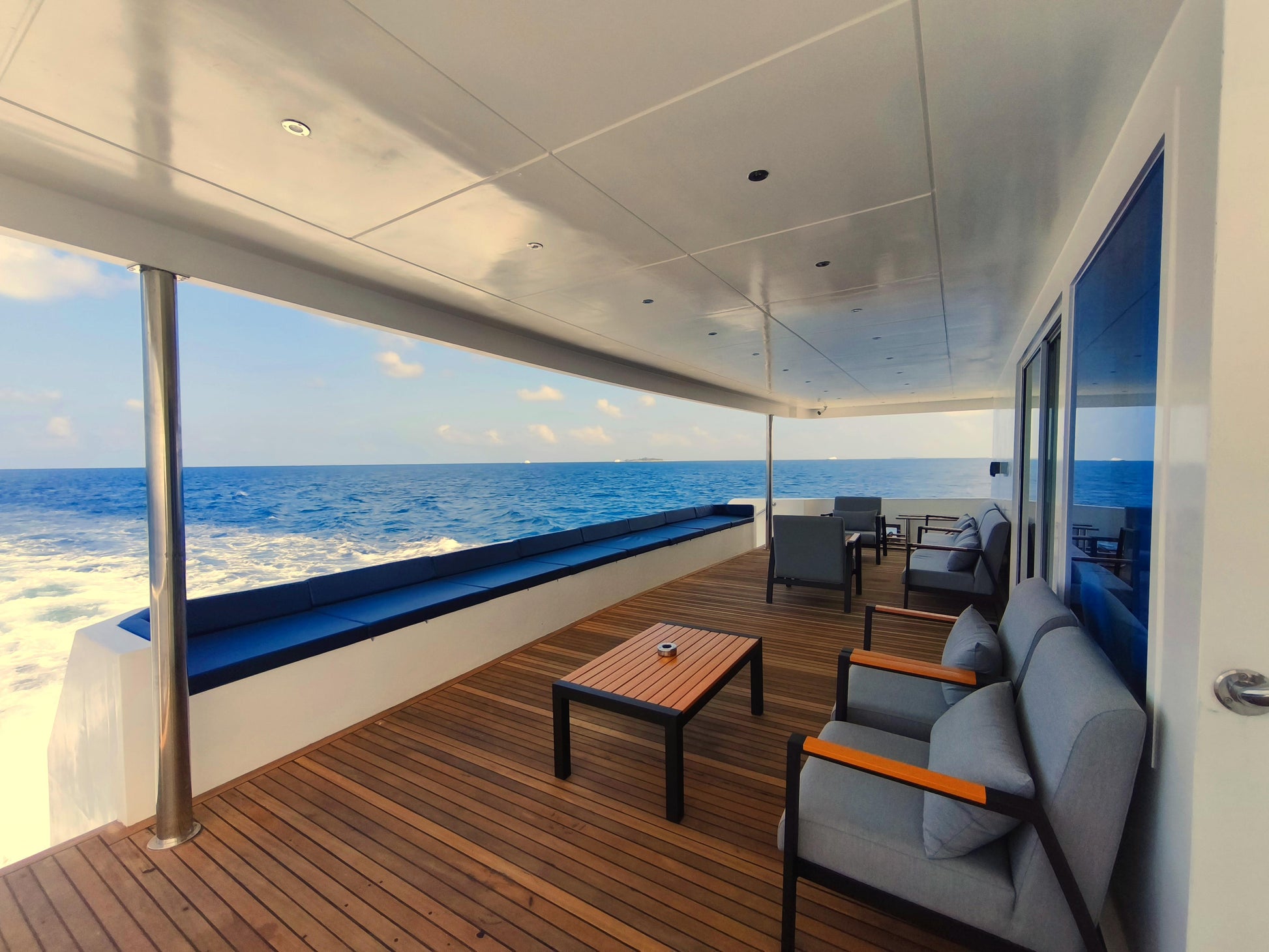 Yacht deck with seating area and ocean view